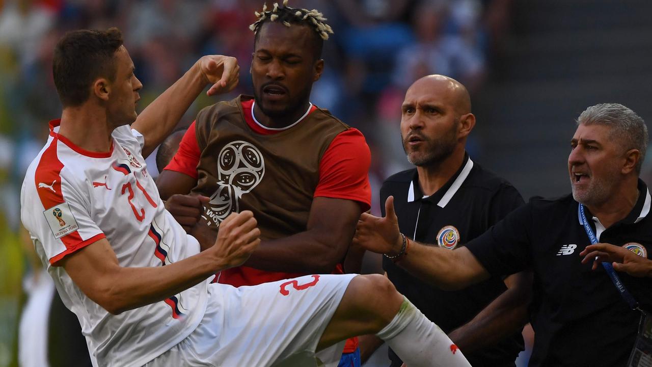 Serbia's midfielder Nemanja Matic (L) in confronted by Costa Rica's defender Kendall Waston.