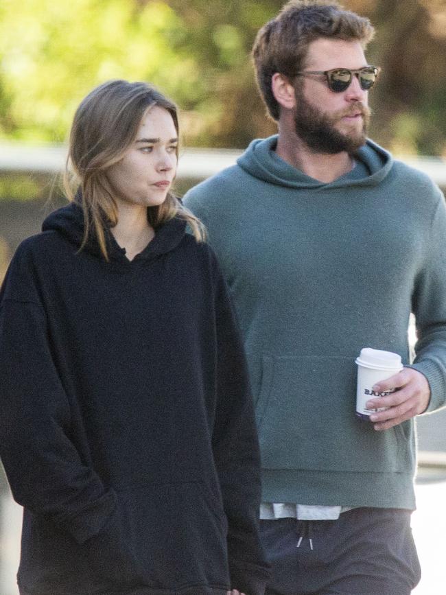 Liam Hemsworth and Gabriella Brooks enjoy a morning snack at the Suffolk Park Bakery in Byron Bay. Picture: Media Mode