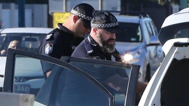 Police searching through a car on the Gold Coast Highway at Miami. Picture Glenn Hampson