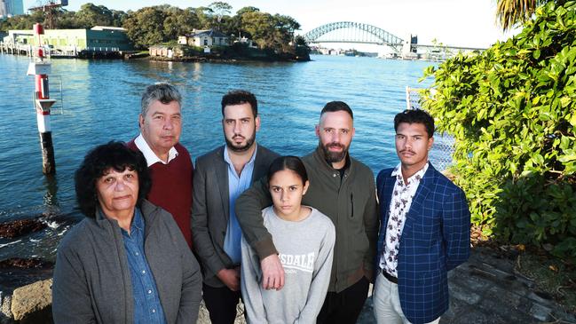 Beverly Simon, left, Lloyd Walker, Ash Walker, Lloyd Walker, Nessa Foster, Michael Ingrey, and David Johnson at Simmons Point Reserve in Balmain East with Goat Island behind them. Picture: John Feder