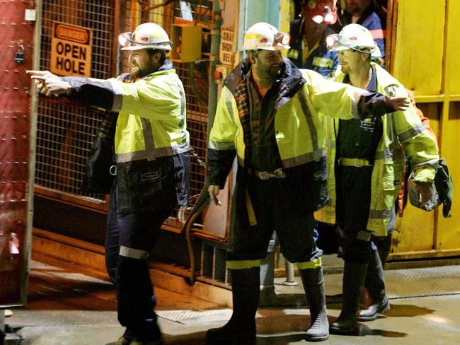 Tasmanian miners Todd Russell and Brant Webb wave as they emerge from the mine lift having been rescued after being trapped underground at Beaconsfield gold mine for 14 days May 9, 2006. AFP PHOTO/POOL