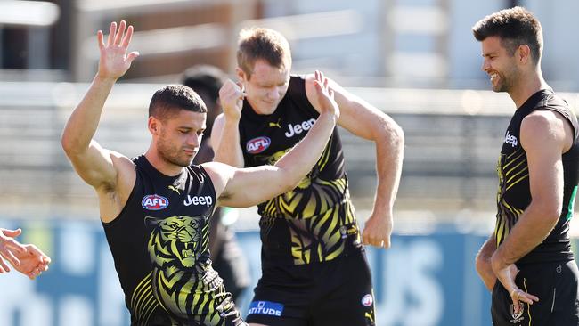 Jack Riewoldt (middle) and Dion Prestia (left) enjoy a lighter training moment with Trent Cotchin, who stood down as captain in September. Picture: Michael Klein