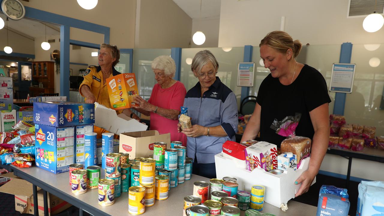 Residents packing food hampers in Wisemans Ferry, which was devastated by flooding on Monday.