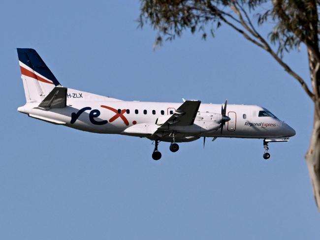 A Rex Airlines Saab 340B prepares to land at Melbourne's Tullamarine Airport on July 30, 2024 after the Australian regional airline announced a trading halt and thus fuelling speculations of financial challenges. (Photo by William WEST / AFP)