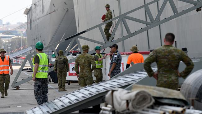 Supplies being loaded onto HMAS Adelaide as it prepares to leave Garden Island naval base, to assist with the ongoing bushfire crisis. Picture: AAP Image/Bianca De Marchi