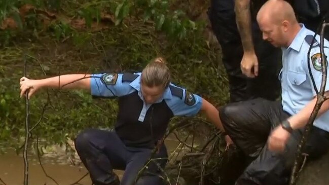 NSW Police officers find the bodies of a man and woman who went missing in flood waters at Wentworthville on Tuesday. Picture: 7 News