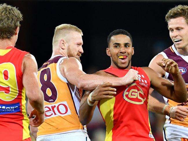 Nick Robertson (second from left) of the Lions is seen grabbing Touk Miller (2nd from right) of the Suns during the Round 22 AFL match between the Gold Coast Suns and the Brisbane Lions at Metricon Stadium on the Gold Coast, Saturday, August 18, 2018. Picture: AAP Image/Darren England.