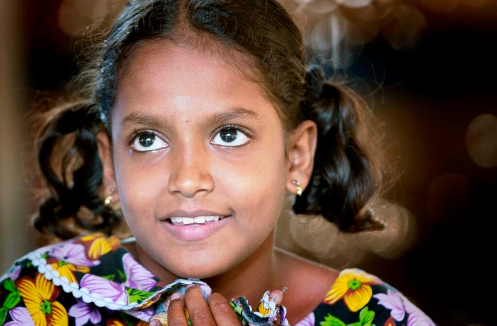 In one village, we tracked down a young girl we had spoken to when we first visited in January 2005. Her beaming smile told the story of new hope in the face of earlier despair. Picture: Kevin Farmer