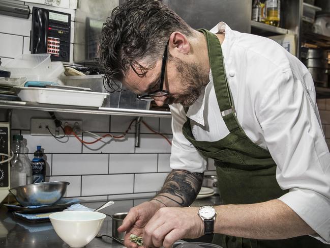 Jock Zonfrillo in the kitchen at Orana,  with a beef main and a cherry desert - pic Mike Burton