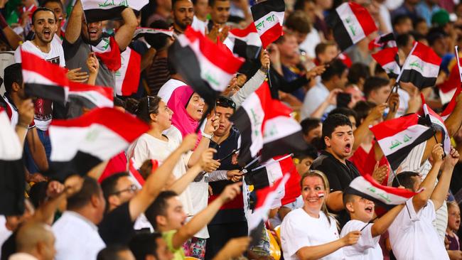 Iraq supporters cheer during the first round Asian Cup football match between Japan and Iraq at the Suncorp Stadium in Brisbane on January 16, 2015. AFP PHOTO / PATRICK HAMILTON ---IMAGE RESTRICTED TO EDITORIAL USE - STRICTLY NO COMMERCIAL USE---