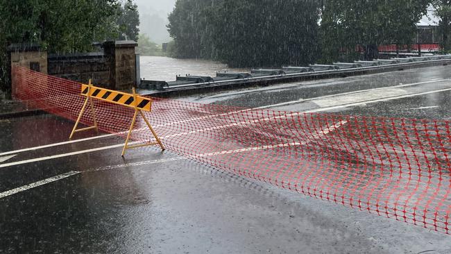 Local SES units are working to flatten the sides of the Picton bridge to allow the water to flow over the bridge without flooding the main street. Picture: Adelaide Lang