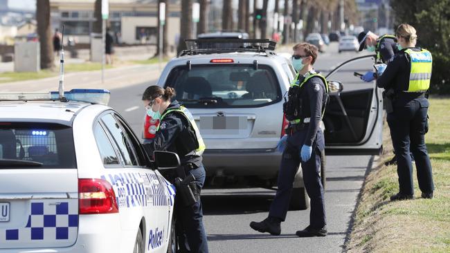 MELBOURNE, AUSTRALIA- NewsWire Photos SEPTEMBER 1, 2020: Police conduct roadside checks in Middle Park on he first day of spring as people are seen exercising along the foreshore during a stage four COVID-19 lockdown in Melbourne. Picture: NCA NewsWire/ David Crosling
