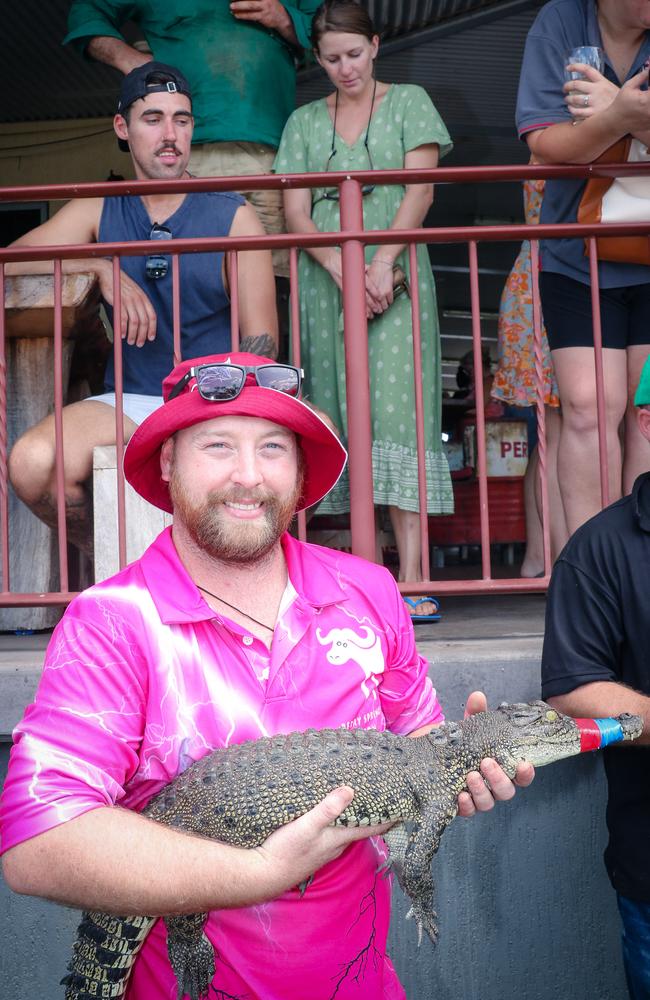 Jordan Gartshore with ‘Soft Croc’ at the Berry Springs Croc Races celebrating the Melbourne Cup Picture: Glenn Campbell