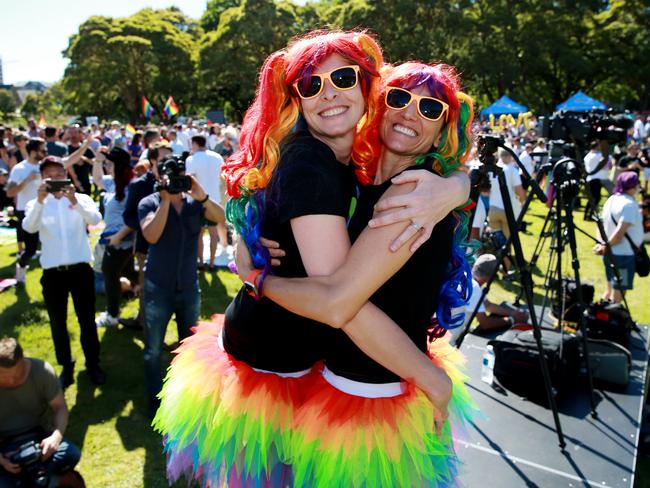 Marriage Equality supporters gather at Prince Alfred Park in Surry Hills ahead of the plebiscite announcement. Sharlini Scholtz (L) and Devon Indig. Picture: Toby Zerna