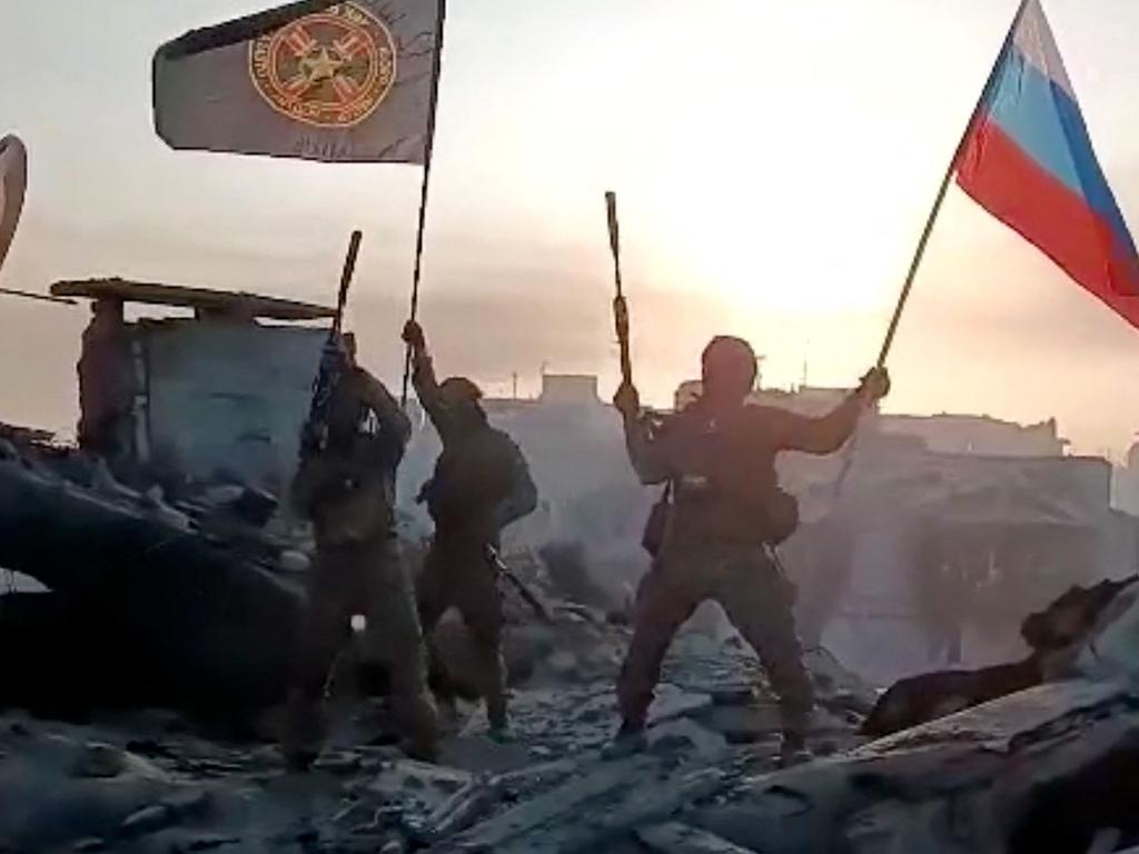 Members of Wagner group waving a Russian national flag and Wagner Group's flag on the rooftop of a damaged building in Bakhmut, amid the Russian invasion of Ukraine. Picture: Handout / various sources / AFP