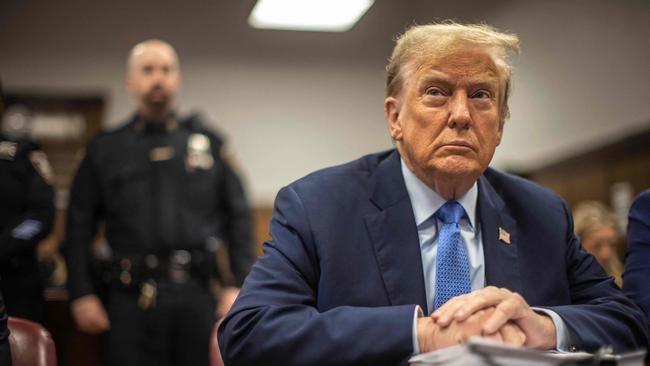 Cold and without Diet Coke, former president Donald Trump muddles through the dreary life of a defendant. Picture: AFP