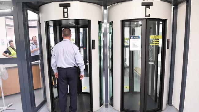 Regular visitors walk through a biometric scanner, like the ones used in an airport, at the Woodford Correctional Centre. Picture: Patrick Woods.