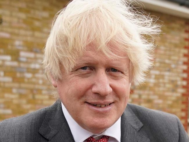 A handout image released by 10 Downing Street, shows Britain's Prime Minister Boris Johnson holding a birthday cake presented to him by the staff during a socially distanced visit to Bovingdon Primary School in Bovingdon, Hemel Hempstead, Hertfordshire on June 19, 2020,  following the announcement of a one billion pound plan to help pupils catch up with their education before September after spending months out of school during the novel coronavirus COVID-19 lockdown. (Photo by Andrew PARSONS / 10 Downing Street / AFP) / RESTRICTED TO EDITORIAL USE - MANDATORY CREDIT "AFP PHOTO / 10 DOWNING STREET / ANDREW PARSONS " - NO MARKETING - NO ADVERTISING CAMPAIGNS - DISTRIBUTED AS A SERVICE TO CLIENTS