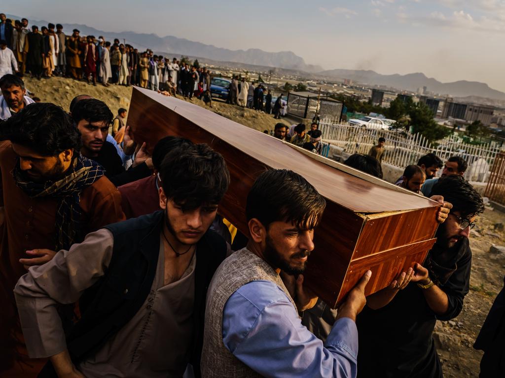 Family carry the caskets at the mass funeral. Picture: Marcus Yam/Los Angeles Times