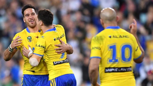 Corey Norman (left) of the Eels is congratulated by Mitchell Moses after kicking a field goal during the round 20 NRL match between the West Tigers and the Parramatta Eels at ANZ Stadium in Sydney on Sunday, July 23, 2017. (AAP Image/Paul Miller) NO ARCHIVING, EDITORIAL USE ONLY