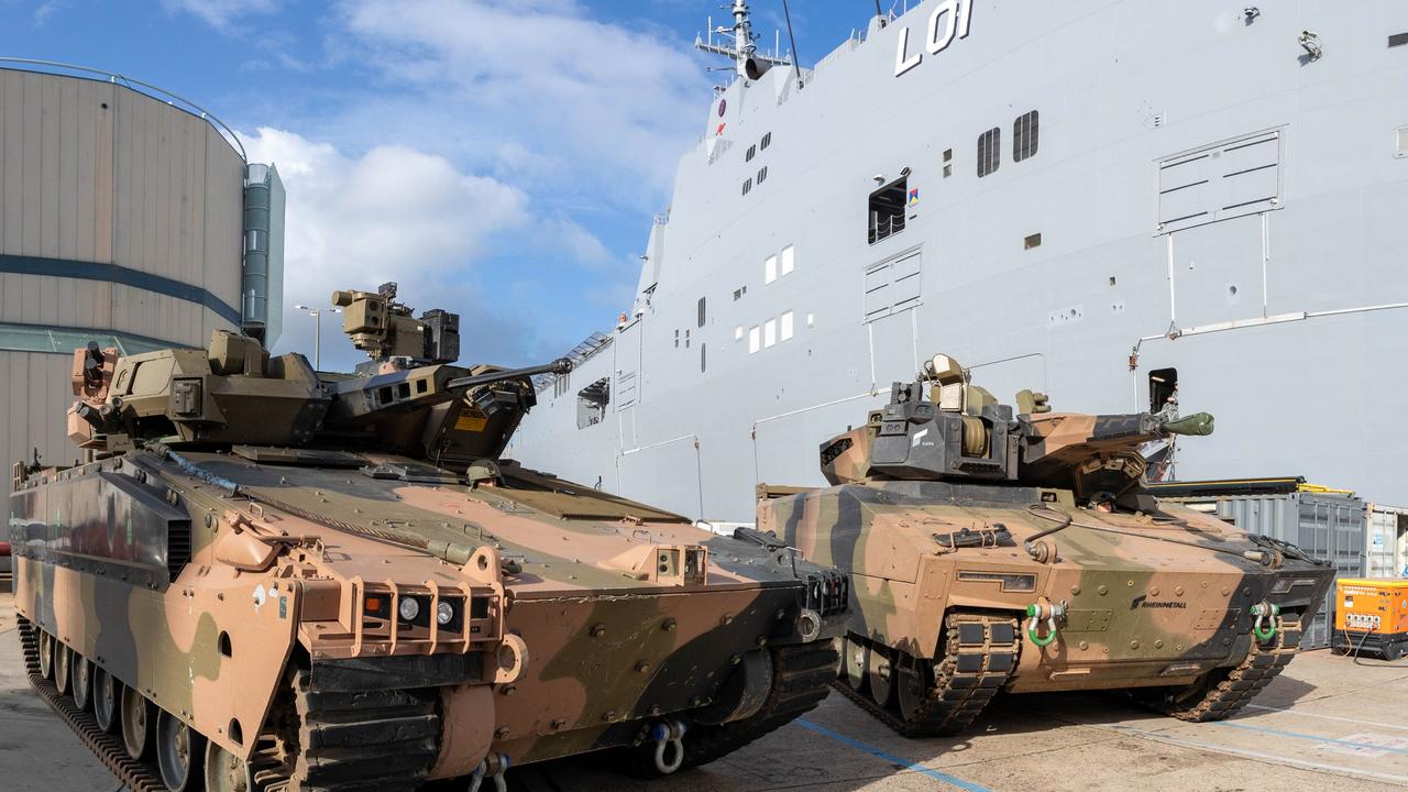 Australian Army Infantry Fighting Vehicles, Hanwha Defense Australia Redback (left) and the Rheinmetall Defence Australia KF-41 Lynx, stand ready to board HMAS Adelaide in Sydney as part of “sea transportability” trials.