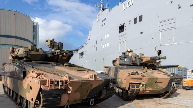 Australian Army Infantry Fighting Vehicles, Hanwha Defense Australia Redback (left) and the Rheinmetall Defence Australia KF-41 Lynx, stand ready to board HMAS Adelaide in Sydney as part of “sea transportability” trials.