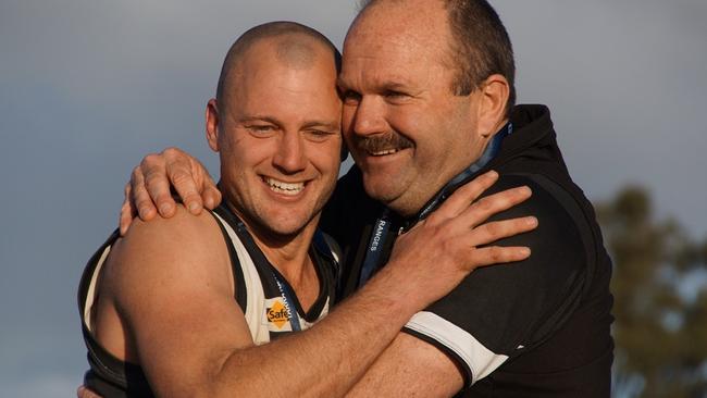 Coach Richard Brown hugs club legend Thomas Stubley after Belgrave’s premiership win. Picture: Robyn Kuys