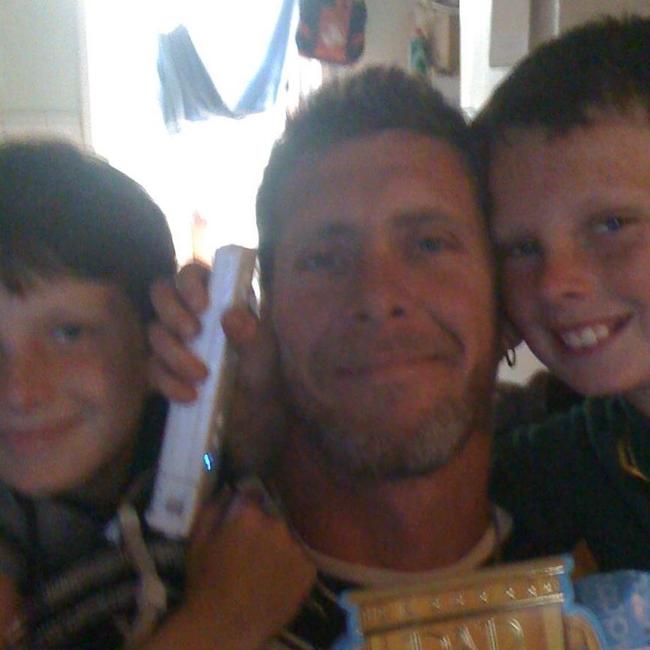 Wynnum's Michael Whitney, who passed away in a tragic accident while trying to fix his tyre, with his two sons. Picture: Facebook