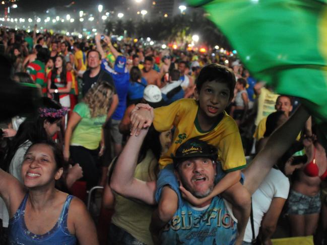 Brazilian fans celebrate during the Fan Fest at Copacabana beach in Rio de Janeiro, Brazil, on July 4, 2014 after the squad beat Colombia in a FIFA World Cup quarter-final football match. AFP PHOTO/TASSO MARCELO