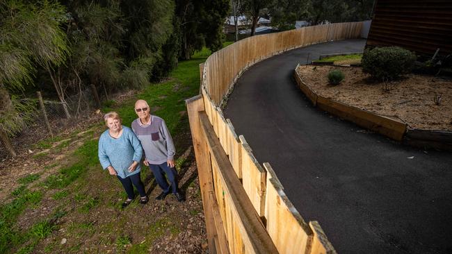 Jill and Brian Boswell standing by the new driveway they got out of the decision to sell their back yard. Picture: Jake Nowakowski.