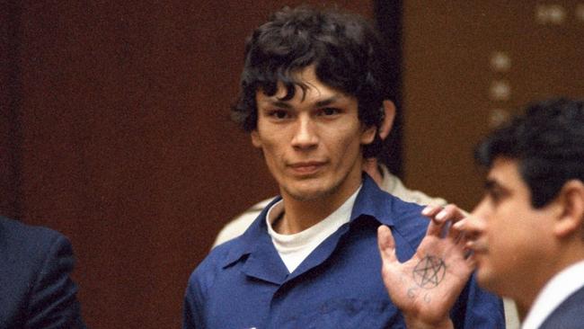 The ‘Night Stalker’ Richard Ramirez displays a pentagram symbol on his hand inside a Los Angeles courtroom in 1985. Picture: AP /Lennox McLendon.