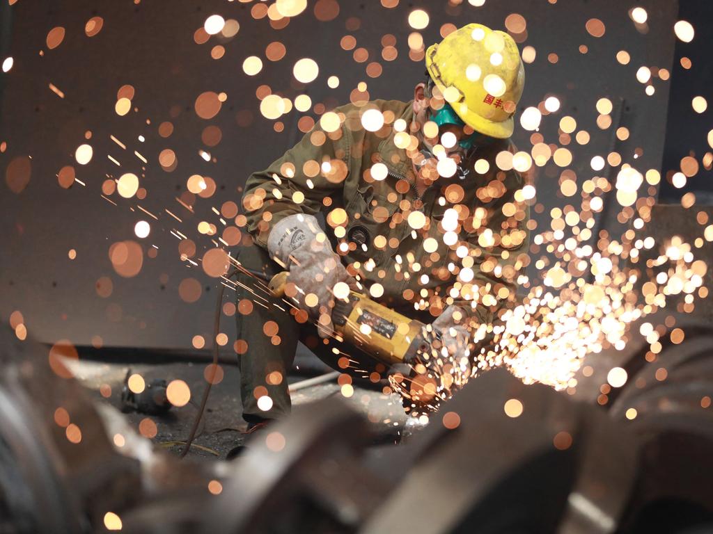 A worker welding metal at a factory in Hangzhou, China. Picture: AFP