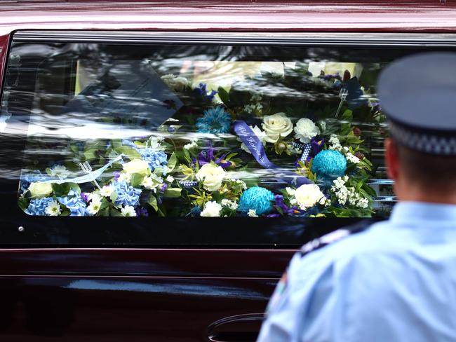 A hearse passes the guard of honour at the memorial service with full police honours for constables Rachel McCrow and Matthew Arnold at Brisbane Entertainment Centre. Picture: David Clark