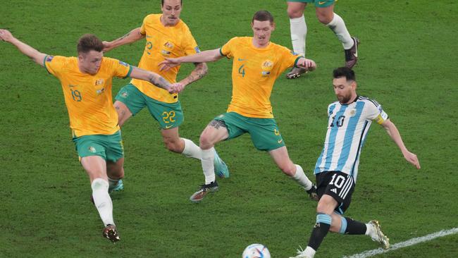 DOHA, QATAR - DECEMBER 03: Lionel Messi of Argentina in action under pressure from Harry Souttar, Jackson Irvine and Kye Rowles of Australia during the FIFA World Cup Qatar 2022 Round of 16 match between Argentina and Australia at Ahmad Bin Ali Stadium on December 03, 2022 in Doha, Qatar. (Photo by Etsuo Hara/Getty Images)