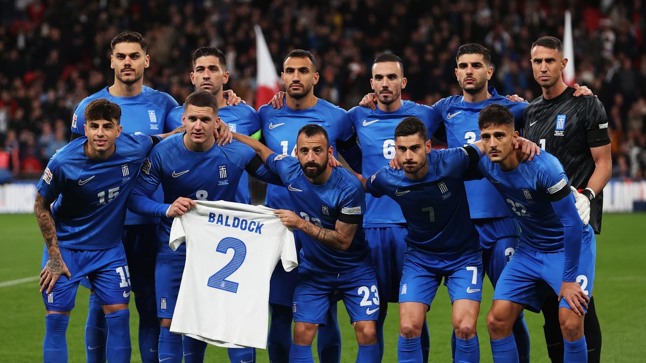 The players of Greece pose for a team photo while holding a shirt which reads 'Baldock 2'. (Photo by Julian Finney/Getty Images)