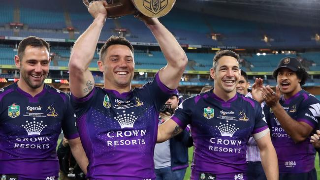 SYDNEY, AUSTRALIA — OCTOBER 01: Cooper Cronk of the Storm walks off the field with team mates Billy Slater and Cameron Smith after winning the 2017 NRL Grand Final match between the Melbourne Storm and the North Queensland Cowboys at ANZ Stadium on October 1, 2017 in Sydney, Australia. (Photo by Cameron Spencer/Getty Images)