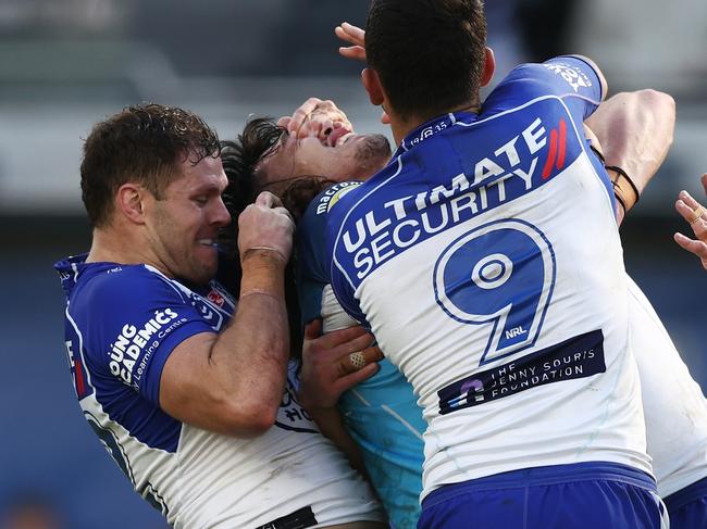 SYDNEY, AUSTRALIA - JULY 24:  Corey Waddell of the Bulldogs tackles Tino Fa'asuamaleaui of the Titans with his hands on his eyes during the round 19 NRL match between the Canterbury Bulldogs and the Gold Coast Titans at CommBank Stadium, on July 24, 2022, in Sydney, Australia. (Photo by Matt King/Getty Images)