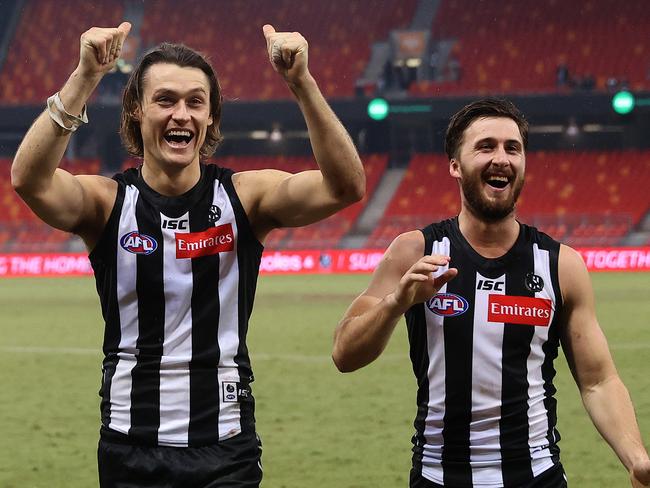 Collingwood's Darcy Moore and Tom Phillips celebrate as they leave the field during the AFL match between Collingwood and Hawthorn at Giants Stadium on July 10th 2020, Sydney. Picture. Phil Hillyard