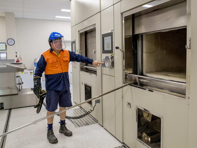 A worker operating a cremation chamber. FILE PIC Picture: Jerad Williams