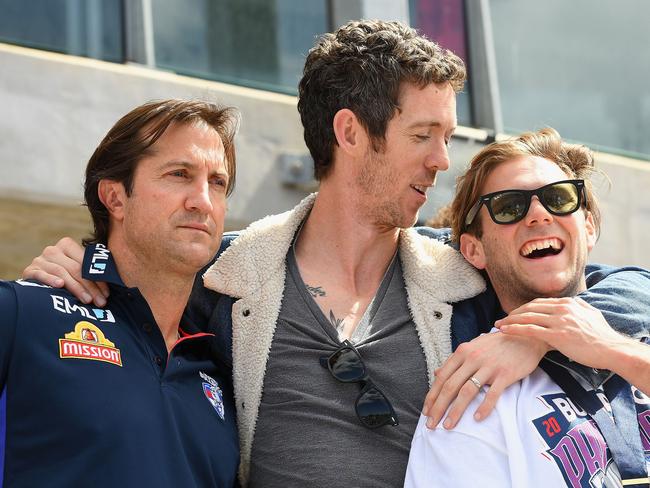 MELBOURNE, AUSTRALIA - OCTOBER 02:  Luke Beveridge, Robert Murphy and Caleb Daniel of the Bulldogs embrace during the Western Bulldogs AFL Grand Final celebrations at Whitten Oval on October 2, 2016 in Melbourne, Australia. The Western Bulldogs defeated the Sydney Swans in yesterday's AFL Grand Final.  (Photo by Quinn Rooney/Getty Images)