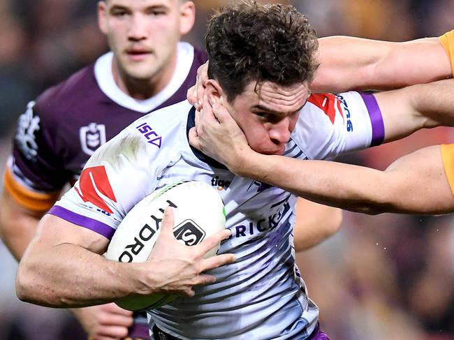 BRISBANE, AUSTRALIA - AUGUST 02: Brodie Croft of the Storm attempts to break away from the defence during the round 20 NRL match between the Brisbane Broncos and the Melbourne Storm at Suncorp Stadium on August 02, 2019 in Brisbane, Australia. (Photo by Bradley Kanaris/Getty Images)