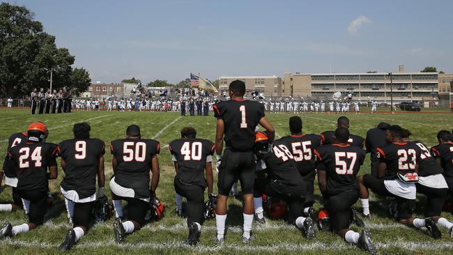 Woodrow Wilson High's Edwin Lopez stood while the rest of his teammates knelt.