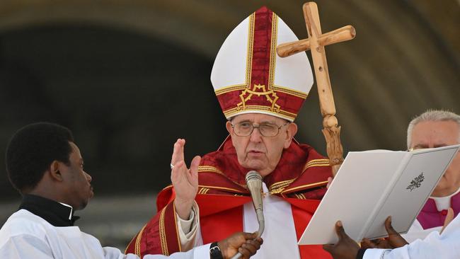 Pope Francis blesses the faithful as he delivers the Angelus prayer at the end of the Palm Sunday mass. Picture: AFP