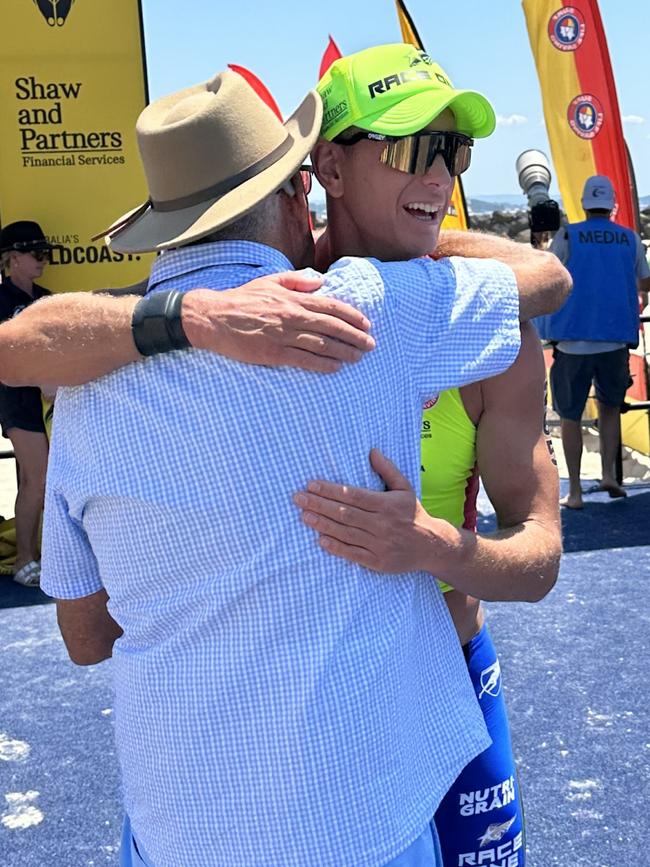 Coolangatta Gold winner Ali Day embraced by Rosco Day, his father, after winning the event for a ninth time. Picture: Jake Garland