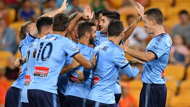 Aaron Calver, centre, is congratulated by Sydney FC teammates after scoring in the first minute against Brisbane Roar. Picture: AAP