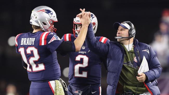 Tom Brady high fives Brian Hoyer (C) and offensive co-ordinator Josh McDaniels during the win over Green Bay: Picture: Getty