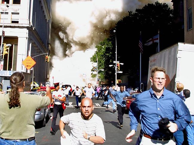 (FILES): This September 11, 2001 file photo shows pedestrians running from the scene as one of the World Trade Center Towers collapses in New York City following a terrorist plane crash on the twin towers.  Seventeen years after the September 11, 2001 attacks, the remains of a 26-year-old finance worker killed in New York has been formally identified thanks to advances in DNA testing, officials announced Wednesday, July 25, 2018.  Scott Michael Johnson is the 1,642nd person to be identified of the 2,753 people killed when two passenger jets, hijacked by Al-Qaeda, destroyed the Twin Towers at the World Trade Center, the symbol of New York's financial wealth. Johnson worked as a securities analyst at investment banking company Keefe, Bruyette and Woods, New York's chief medical examiner Barbara Sampson said.  / AFP PHOTO / DOUG KANTER