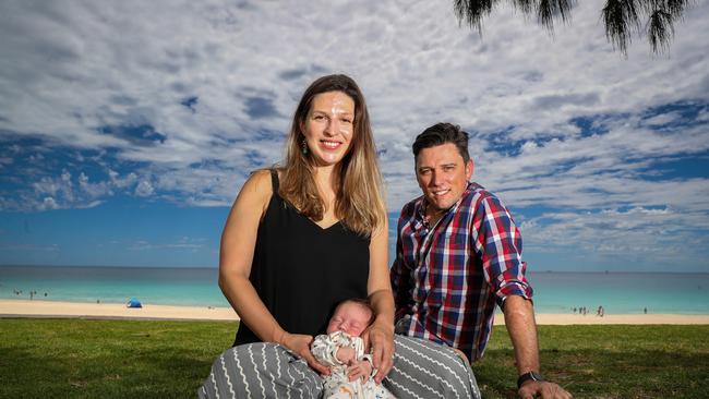 ‘It was all very quiet’ … Clarissa Carradine and husband Jesse Riseborough with three-week-old baby Florence at Perth’s City Beach. Picture: Colin Murty