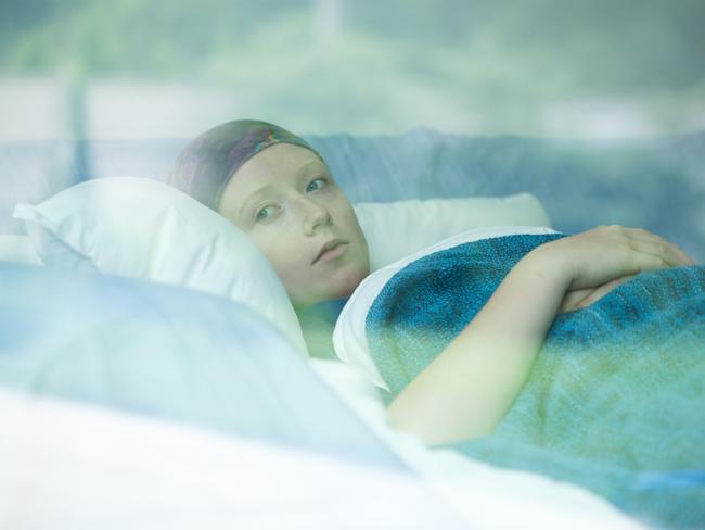 Young woman in bed suffering from cancer Photo: istock