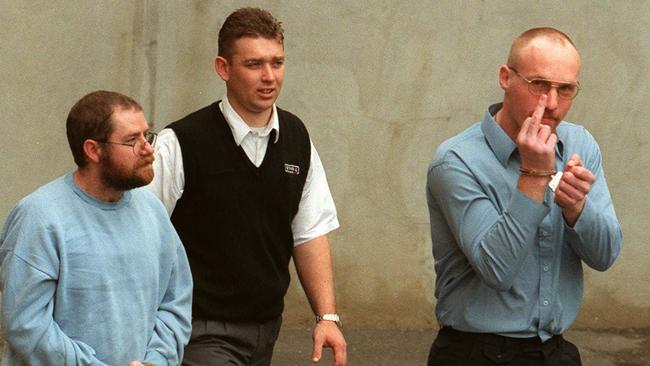 A guard, centre, escorts serial killers John Justin Bunting, left, and Robert Joe Wagner, right, into court following their arrests. Picture: Michael Milnes.